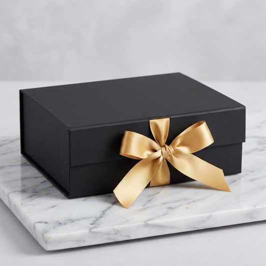 BellePanthere luxury gift wrapping service — matte black gift box with gold satin ribbon